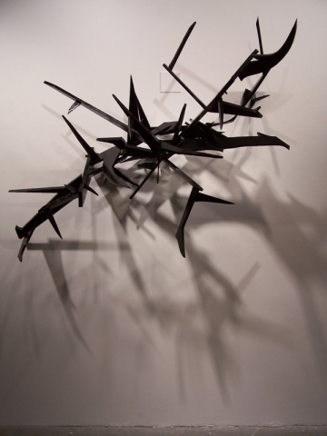 Metal logo sculpture by artist Owen Rundquist
