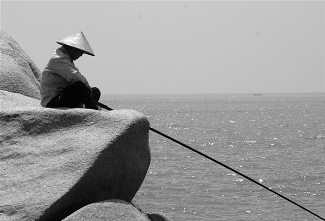 Fisherman on the rocks - Hainan