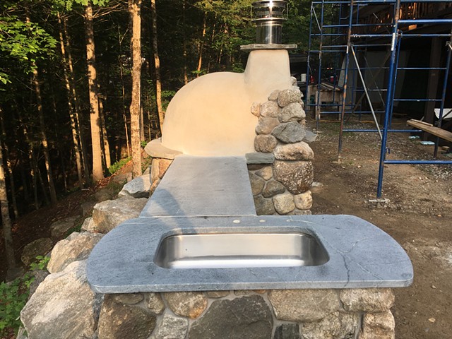 The basin is repurposed, the soapstone was salvaged, and the stone came right from the property.