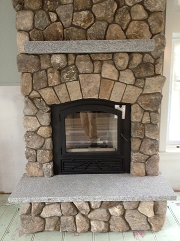 Cut stone arch and granite hearth and mantle