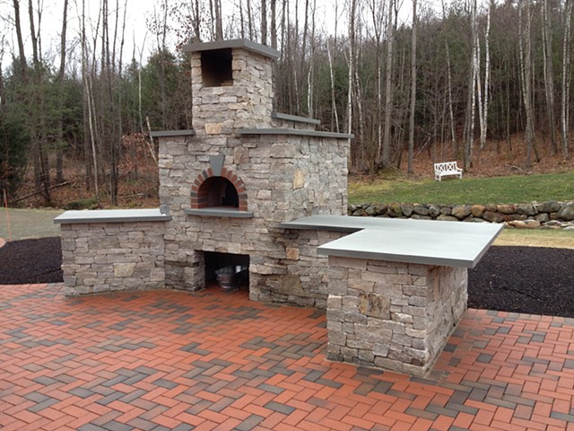 Natural brick and stone outdoor pizza oven with a Forno Bravo core