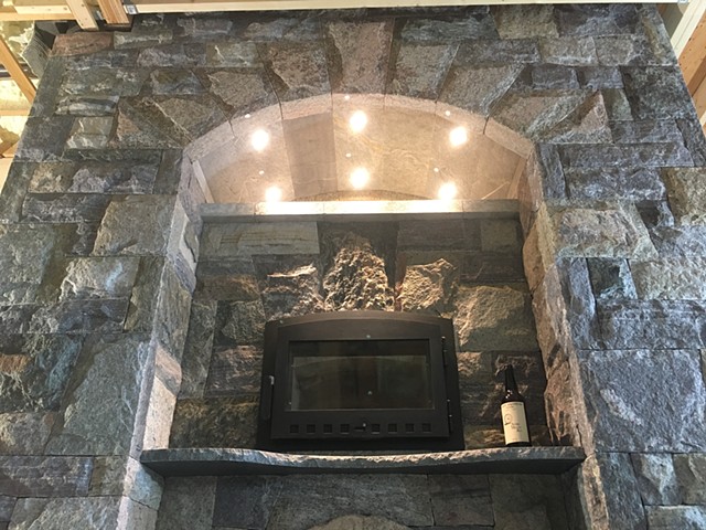 The intrados of the soapstone arch contain down lighting for the oven. 