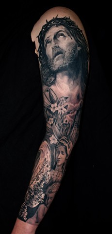 religious sleeve tattoo by chris lowe of naked art tattoos odenton maryland