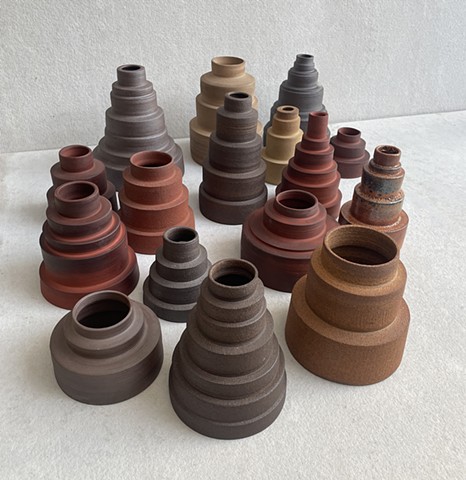 My most recent project is a collection of tiered cylinders thrown on the wheel. They draw from ancient architectural forms like stupas and ziggurats, and mechanical parts like car transmissions. They also read as figures. I’m calling the project “El Pueblo Unido” - a town or people, united -  to honor this year of protest. These pieces work most effectively in a group. 