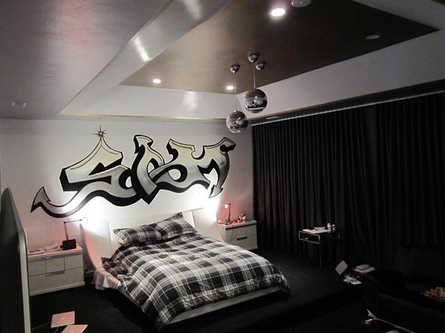 Killer teen room painted with high gloss walls, gold and silver ceiling, and graffiti themed mural. Room designed by Julie Abner.