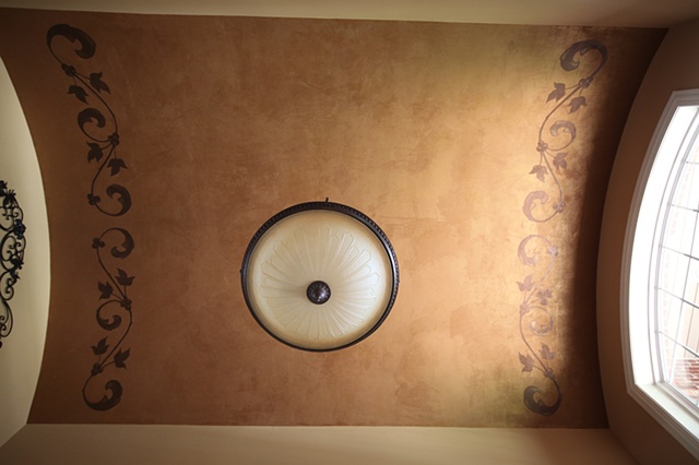 Hand painted pattern on gold finish ceiling.