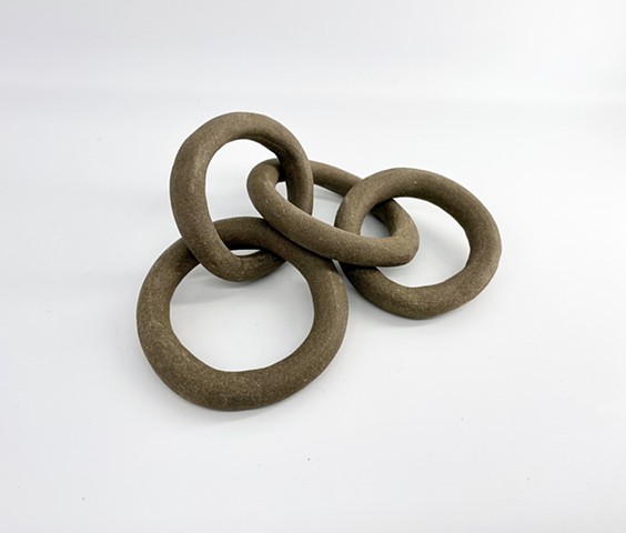 4 link circular link chain (Black mountain clay) This hand made chain of four links displays beautifully on a shelf or stack of books or your coffee table. clay fired sculpture. 