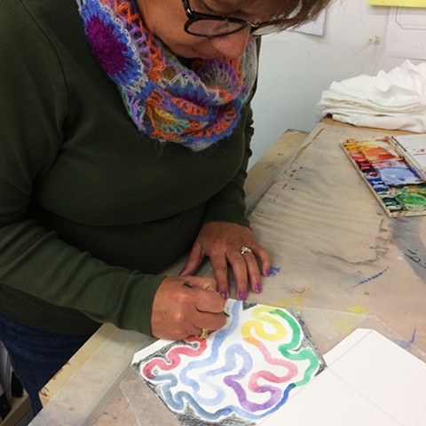 Stephanie adds her signature to her work, titled  Transitions. 
