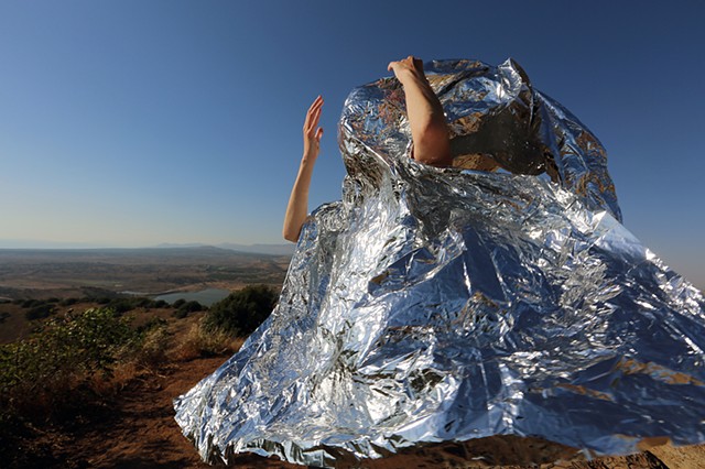 photograph in Golan Heights of Rena Leinberger wrapped in foil blanket emergency blanket