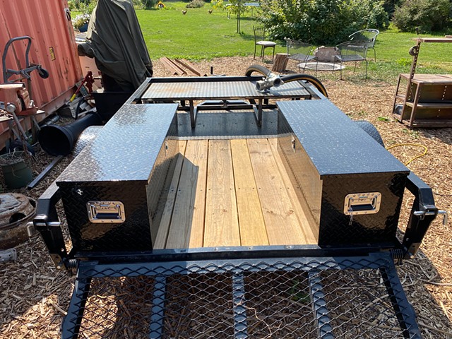 Boiler trailer build out in progress with chickens in background.