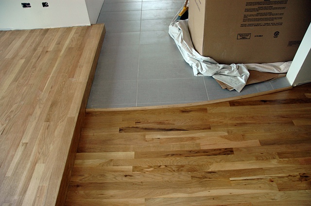 junction of master bedroom entry tile, reading platform and oak floors