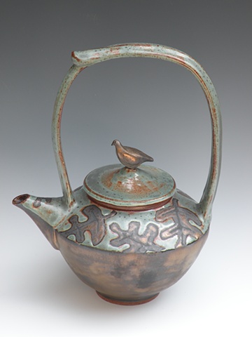 Patina green teapot with gold oak leaves and bird on lid.
