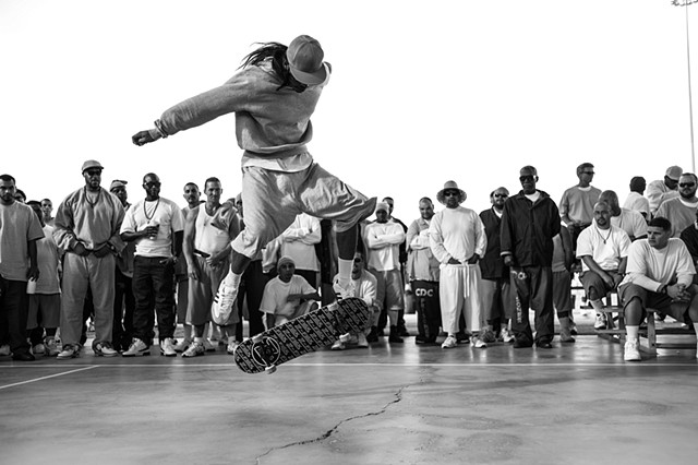 Inmate Skateboarding on the yard in Prison. 