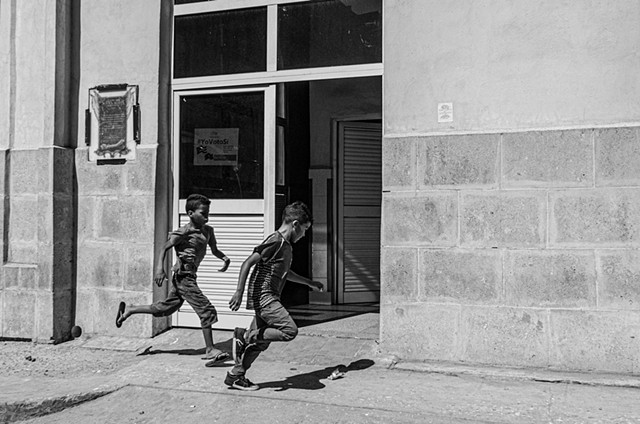 Kids playing with a paper. Havana, Cuba.
