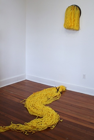 Crocheted fiber combines with found objects to comment on sexual politics.