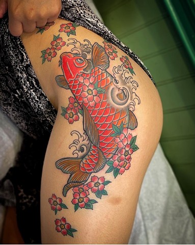 A red traditional Japanese koi with sakura "cherry blossoms" on the hip