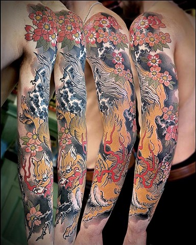 A traditional Japanese full sleeve, featuring a fire breathing kitsune "fox", and sakura "cherry blossoms".