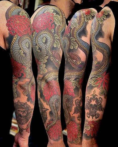 A traditional Japanese full sleeve, featuring a brown and blue snake and red chrysanthemum flowers