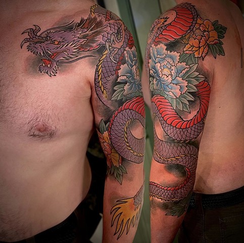 A traditional Japanese 3/4 sleeve, from chest to forearm, featuring a lavender dragon and colorful peony flowers