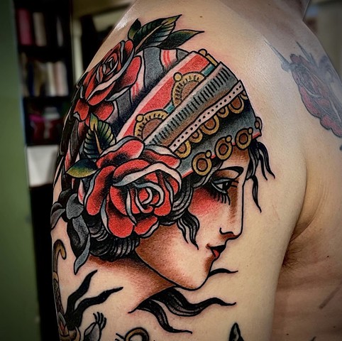 A Western Traditional style Roma Girl "Gypsy" with red roses and a blue and red bandana