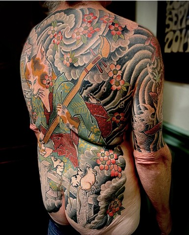 The right side view of a traditional Japanese back piece, featuring a cat playing a samisen with onlooking mice and fluttering sakura "cherry blossoms"