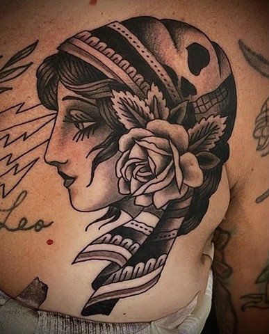 A black and grey colored Roma Girl "Gypsy", with a skull print bandana and a rose in her ear