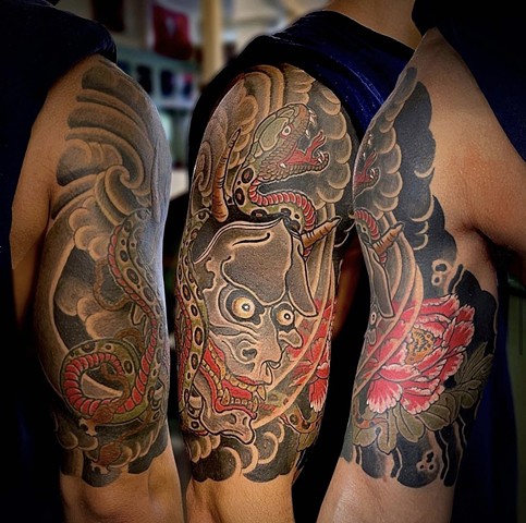 A traditional Japanese 1/2 sleeve featuring a Hannya mask and snake, and red peony flower