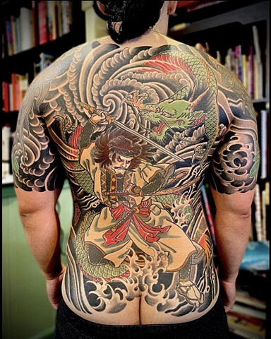 A traditional Japanese back piece featuring a samurai and green dragon