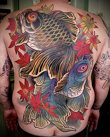 A Japanese fantail goldfish back piece extensively covering older tattoos. Two goldfish accompanied by maple leaves   
