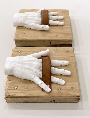 Â¡DARN! 2025 Installation detail â€“ wood, nails, leather, digitally printed hands â€“ each: 23x20x10cm.