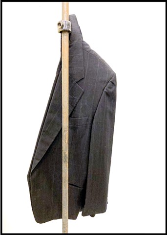 Â¡DARN! 2025 Installation detail â€“ steel rod [183x2cm] with bracket and wool suit jacket [92x33cm]