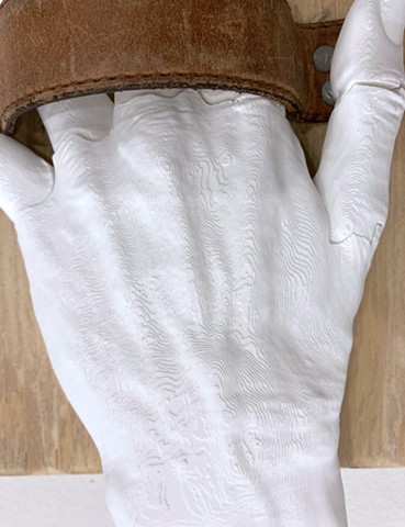 Â¡DARN! 2025 Installation detail â€“ wood, nails, leather, digitally printed hands â€“ each: 23x20x10cm.