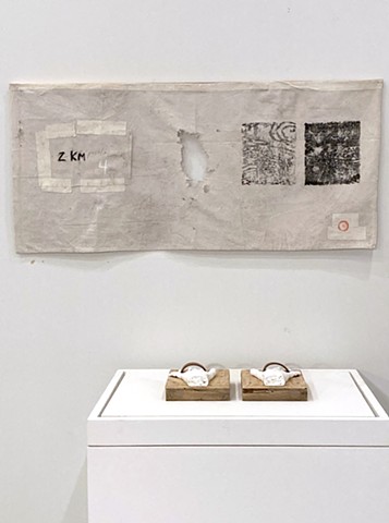 Â¡DARN! 2025 Installation detail â€“ canvas drop cloth remnant, white cloth tape, pencil, oil stick, stamp ink, block print cloth ink, wood, nails. 61x135cm.