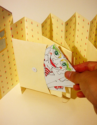 Illustration being pulled out of envelopes in an artist book