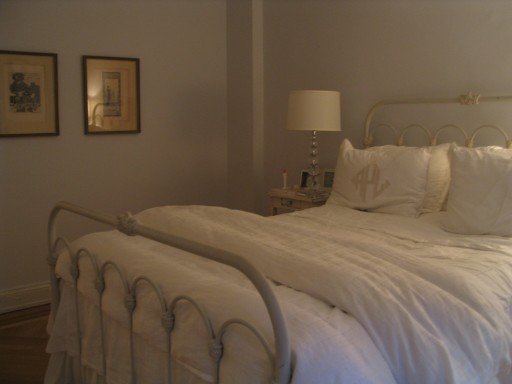 Simple off white bedding and furniture create a serene bedroom by Jane Interiors NYC