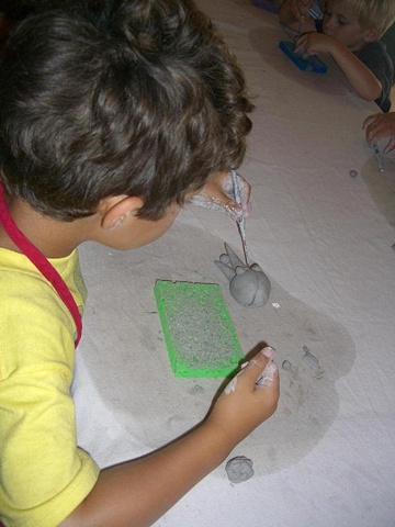 Four year old working on clay project.