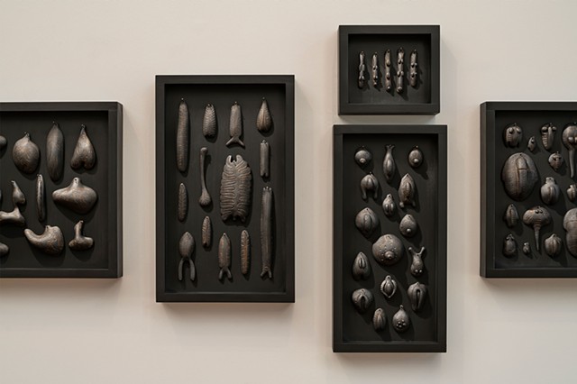 Forms of Life (detail) | black clay, graphite, gold pigment, pins, wood panels | Center left panel: 18 x 11 x 2 inches
