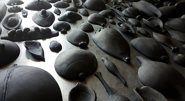 fired seeds, ready for pigment | black clay | dimensions vary