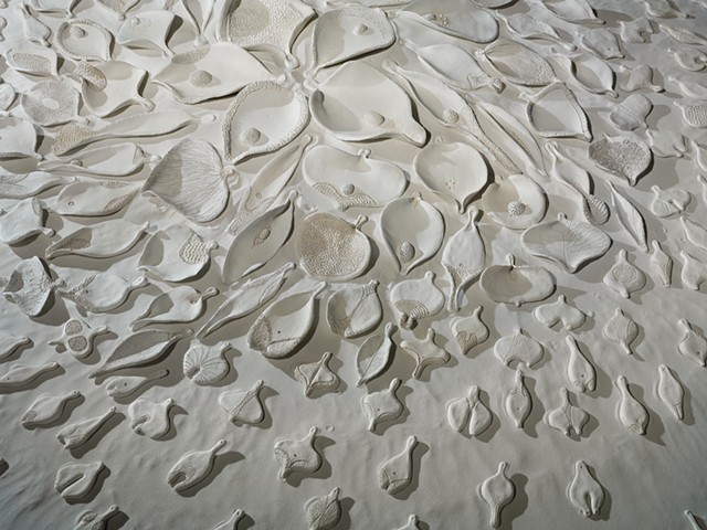 detail of floor installation by Mary Meyer comprised of painted ceramic and sand