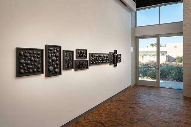 Forms of Life | black clay, graphite, gold pigment, pins, wood panels | Wall installation 14 ft.