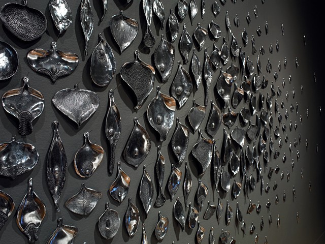 detail of wall installation by Mary Meyer comprised of cast aluminum and sewing needles