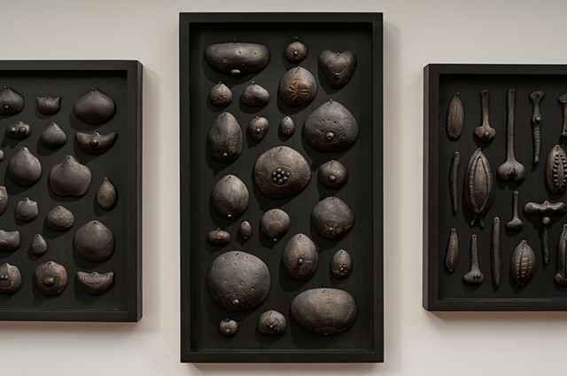 Forms of Life (detail) | black clay, graphite, gold pigment, pins, wood panels | Center panel: 24 x 14 x 2 inches