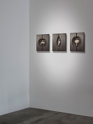 wall sculptures comprised of cast aluminum, wood, graphite, and sewing needles by Mary Meyer