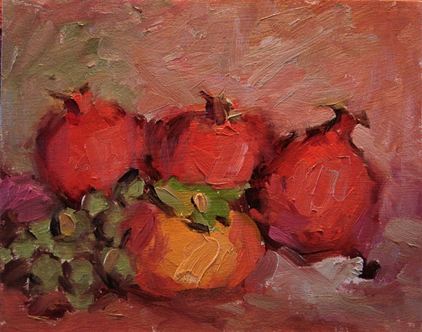 Still life of pomegranates, a persimmon and a bunch of grapes