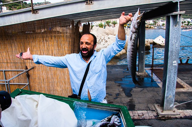 A fish vendor hawking his daily catch