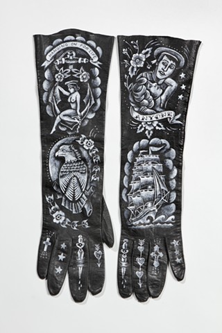 traditional tattoo designs on vintage leather gloves with sailor motifs