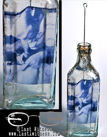 photo emulsion suspended in resin casted inside vintage medicine bottle with tattoo needle hanger 