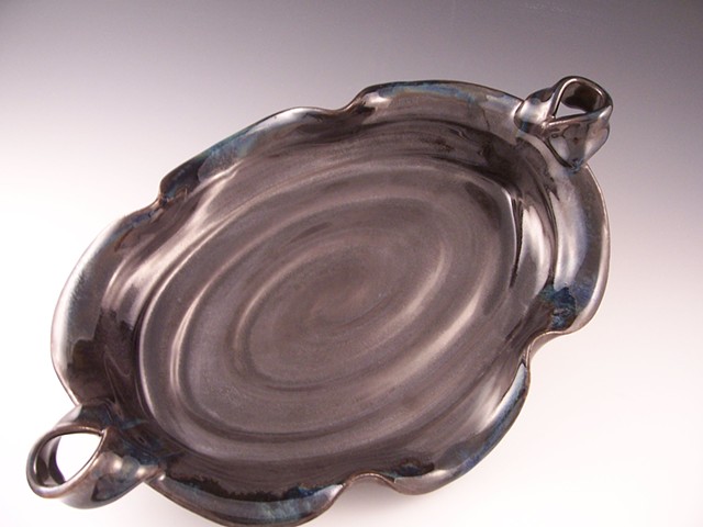 This piece was thrown first on the wheel, then on the floor, literally, glazed in my new metallic black glaze!