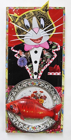 A dapper cat is excited by the fish on his plate.