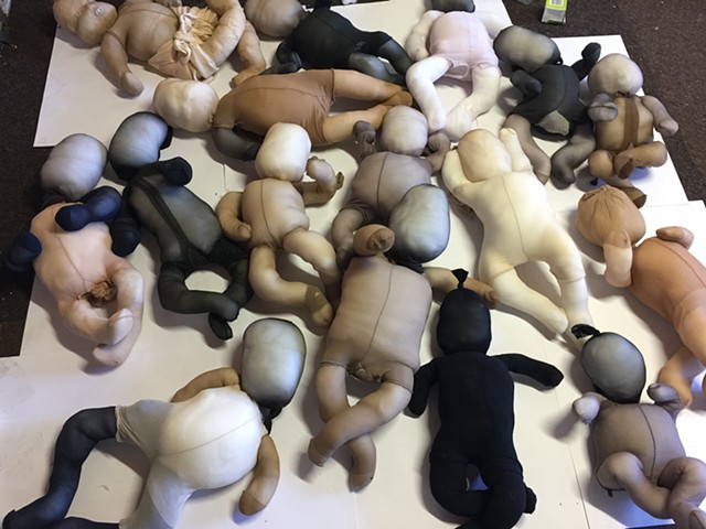 soft sculpture babies in my studio before there faces for installation.